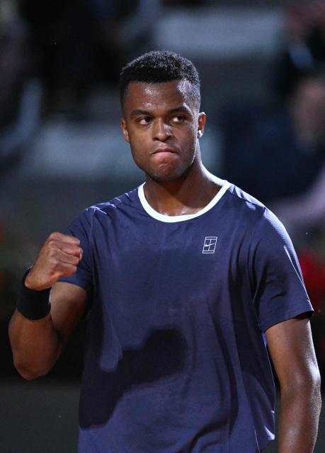France's Giovanni Mpetshi Perricard reacts after winning a point against Italy's Lorenzo Musetti during the men's singles match of the WTA Rome Open tennis tournament at the Foro Italico in Rome on May 8, 2026. (Photo by Tiziana FABI / AFP)