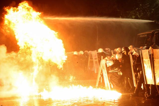 Molotov cocktails explode in front of Albanian riot police officers during an anti-government protest in Tirana on May 8, 2026. (Photo by Adnan Beci / AFP)