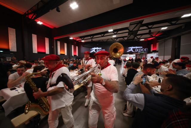 A brass band performs during a big banquet organised by the 'Canon francais' in Montelimar, south-eastern France, on May 8, 2026. The banquets of the 'Canon francais', which draw thousands of guests around roast pork and red wine to "promote local traditions and heritage," are accused by their critics of spreading racist ideas behind their patriotic, typically French image. (Photo by Alex MARTIN / AFP)
