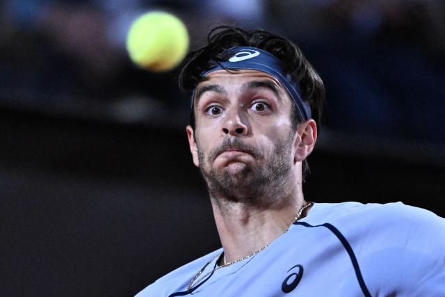 Italy's Lorenzo Musetti eyes the ball before hitting a forehand against France's Giovanni Mpetshi Perricard during the men's singles match of the Rome Masters 1000 tennis tournament at the Foro Italico in Rome on May 8, 2026. (Photo by Tiziana FABI / AFP)