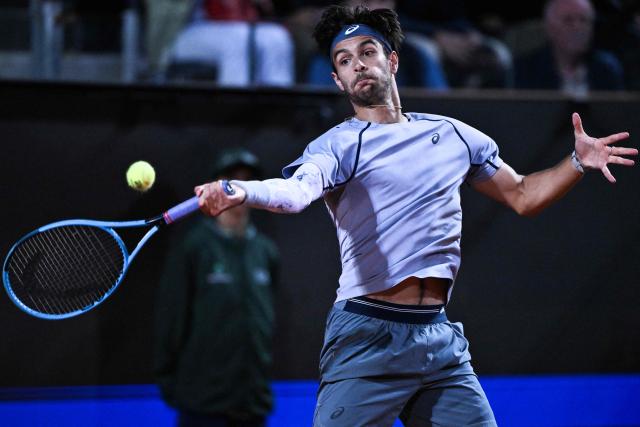 Italy's Lorenzo Musetti hits a return against France's Giovanni Mpetshi Perricard during their men's singles match of the Rome Masters 1000 tennis tournament at the Foro Italico in Rome on May 8, 2026. (Photo by Tiziana FABI / AFP)