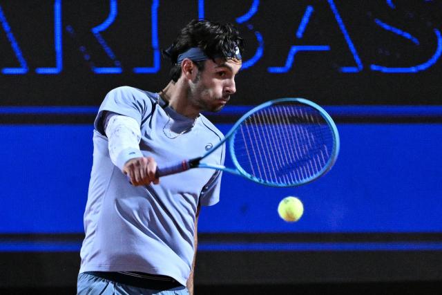 Italy's Lorenzo Musetti hits a return against France's Giovanni Mpetshi Perricard during their men's singles match of the Rome Masters 1000 tennis tournament at the Foro Italico in Rome on May 8, 2026. (Photo by Tiziana FABI / AFP)