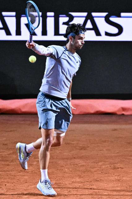 Italy's Lorenzo Musetti hits a return against France's Giovanni Mpetshi Perricard during their men's singles match of the Rome Masters 1000 tennis tournament at the Foro Italico in Rome on May 8, 2026. (Photo by Tiziana FABI / AFP)