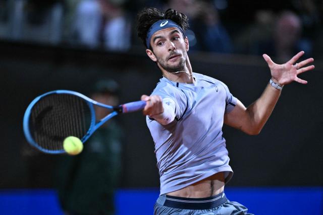 Italy's Lorenzo Musetti hits a return against France's Giovanni Mpetshi Perricard during their men's singles match of the Rome Masters 1000 tennis tournament at the Foro Italico in Rome on May 8, 2026. (Photo by Tiziana FABI / AFP)