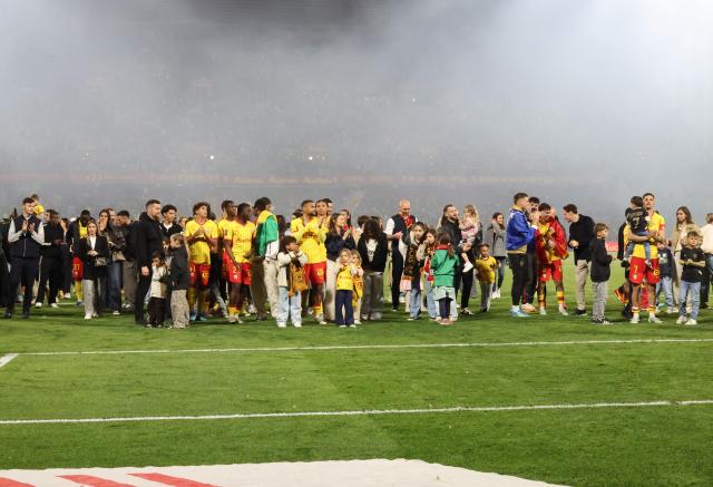 Lens players and their families greet the fans at the end of the French L1 football match between RC Lens and FC Nantes after qualifying for the Champions League following their victory at the Bollaert-Delelis stadium in Lens on May 8, 2026. (Photo by Francois LO PRESTI / AFP)