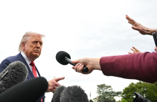 US President Donald Trump speaks to journalists as he makes his way to board Marine One before departing from the South Lawn of the White House in Washington, DC on May 8, 2026. Trump is traveling to Sterling, Virginia, where he will participate in a LIV Golf dinner. (Photo by Mandel NGAN / AFP)