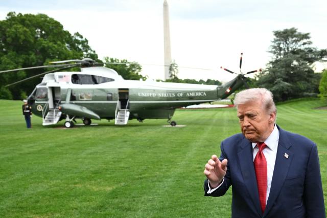 US President Donald Trump gestures as he makes his way to board Marine One before departing from the South Lawn of the White House in Washington, DC on May 8, 2026. Trump is traveling to Sterling, Virginia, where he will participate in a LIV Golf dinner. (Photo by Mandel NGAN / AFP)