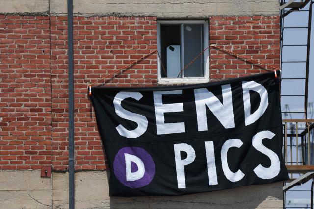 A “Send D Pics” sign hangs from a building window near a train station during the opening of the Metro D Line subway extension in Los Angeles on May 8, 2026. The transit extension adds three new stations along Wilshire Boulevard to Beverly Hills ahead of the 2026 FIFA World Cup with two more extensions of the rail line planned to be completed before the 2028 Summer Olympics. (Photo by Patrick T. Fallon / AFP)