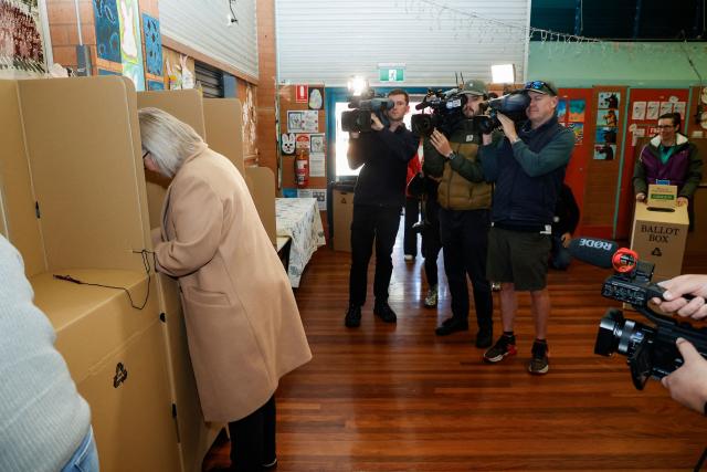 Independent candidate Michelle Milthorpe (L) fills out her ballot before she casts her vote at a polling station during the Farrer By-Election in Jindera, New South Wales on May 9, 2026. (Photo by HILARY WARDHAUGH / AFP)