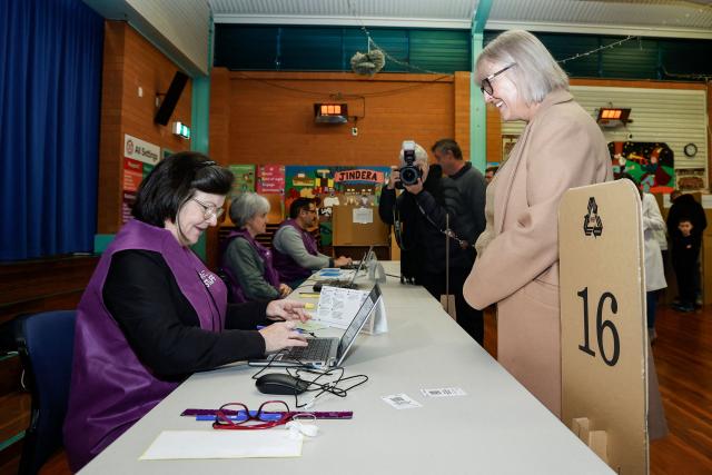 Independent candidate Michelle Milthorpe (R) registers to vote at a polling station during the Farrer By-Election in Jindera, New South Wales on May 9, 2026. (Photo by HILARY WARDHAUGH / AFP)