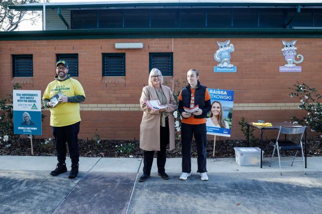 Independent candidate Michelle Milthorpe (C) hands out flyers during the Farrer By-Election in Jindera, New South Wales on May 9, 2026. (Photo by HILARY WARDHAUGH / AFP)