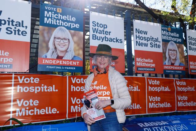 Helen Haines, independent MP for the neighbouring electorate of Indi, poses for a photo in front of Michelle Milthorpe campaign posters outside Albury Primary School during the Farrer By-Election in Albury, New South Wales on May 9, 2026. (Photo by HILARY WARDHAUGH / AFP)