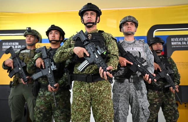 Colombian soldiers pose with new Jaguar rifles at Indumil's General Jose Maria Cordova arms and ammunition factory in the Soacha municipality, near Bogota, on May 8, 2026. (Photo by Raul ARBOLEDA / AFP)