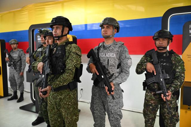 Colombian soldiers pose with new Jaguar rifles at Indumil's General Jose Maria Cordova arms and ammunition factory in the Soacha municipality, near Bogota, on May 8, 2026. (Photo by Raul ARBOLEDA / AFP)