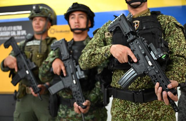 Colombian soldiers pose with new Jaguar rifles at Indumil's General Jose Maria Cordova arms and ammunition factory in the Soacha municipality, near Bogota, on May 8, 2026. (Photo by Raul ARBOLEDA / AFP)