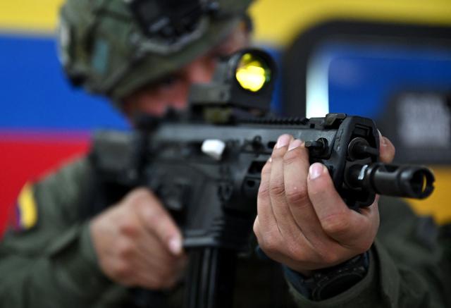 A Colombian soldier poses with a new Jaguar rifle at the General Jose Maria Cordova arms and ammunition factory of Indumil in the Soacha municipality, near Bogota, on May 8, 2026. (Photo by Raul ARBOLEDA / AFP)