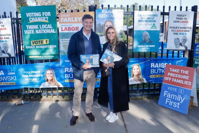 The Leader of the Opposition Angus Taylor (L) and Liberal candidate Raissa Butkowski pose for photos at Lavington Primary School during the Farrer By-Election in Albury, New South Wales on May 9, 2026. (Photo by HILARY WARDHAUGH / AFP)