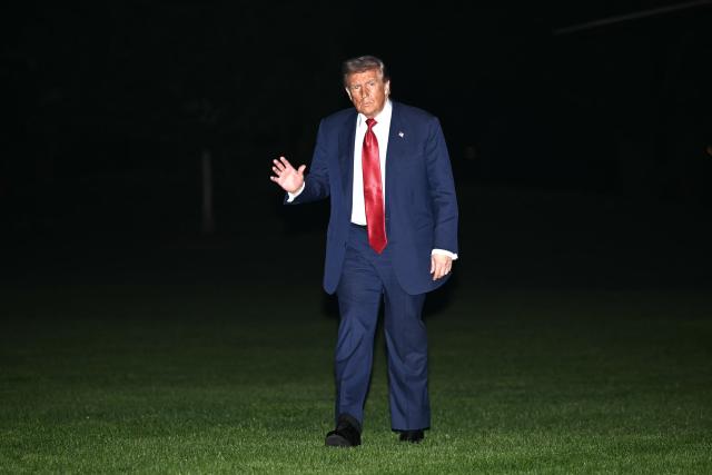 US President Donald Trump waves as he walks across the South Lawn of the White House in Washington, DC, on May 8, 2026. Trump is returning to the White House after attending a LIV Golf dinner in Sterling, Virginia. (Photo by Mandel NGAN / AFP)