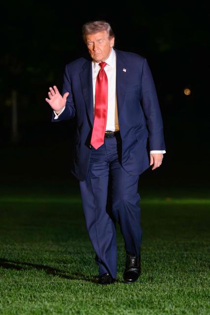 US President Donald Trump waves as he walks across the South Lawn of the White House in Washington, DC, on May 8, 2026. Trump is returning to the White House after attending a LIV Golf dinner in Sterling, Virginia. (Photo by Mandel NGAN / AFP)