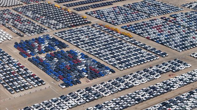 This photo shows an aerial view of cars waiting ot be loaded onto a ship at a storage yard in Yantai, in eastern China's Shandong province on May 9, 2026. (Photo by CN-STR / AFP) / China OUT