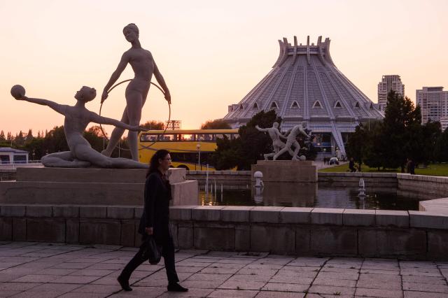 A woman walks outside the Pyongyang Ice Rink in Pyongyang on May 8, 2026. (Photo by KIM Won Jin / AFP)
