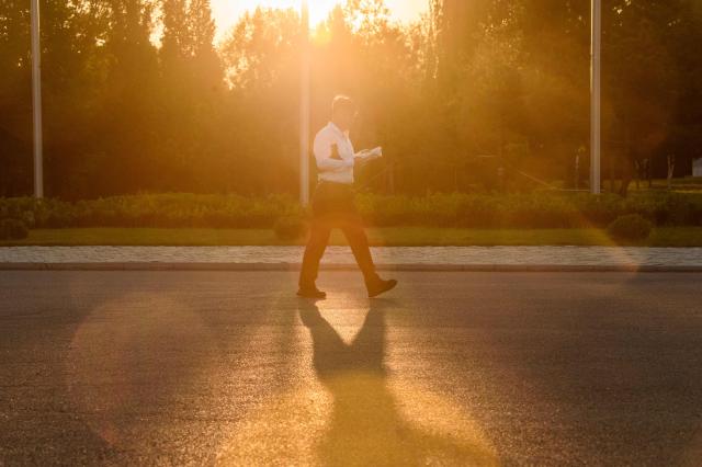 A man reads as he walks outside the Pyongyang Ice Rink in Pyongyang on May 8, 2026. (Photo by KIM Won Jin / AFP)