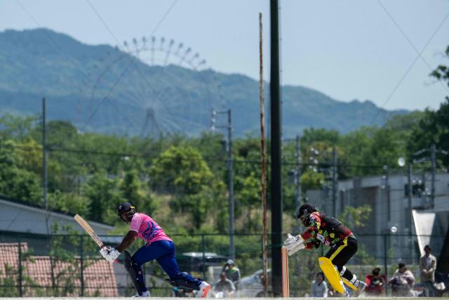 Japan’s Esam Rahman (L) plays a shot as Vanuatu’s wicketkeeper Clement Tommy looks on during their ICC T20 World Cup East Asia-Pacific Qualifier cricket match at the Nisshin Cricket Ground at Korogi Sports Park in Nisshin, Aichi Prefecture on May 9, 2026. (Photo by ANDREW CABALLERO-REYNOLDS / AFP)
