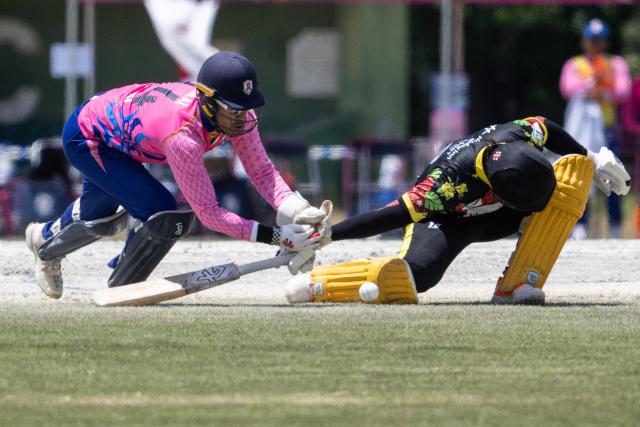 Japan’s Alex Shirai-Patmore (L) dives for the ball as Vanuatu’s Junior Kaltapau makes for the crease during their ICC T20 World Cup East Asia-Pacific Qualifier cricket match at the Nisshin Cricket Ground at Korogi Sports Park in Nisshin, Aichi Prefecture on May 9, 2026. (Photo by ANDREW CABALLERO-REYNOLDS / AFP)