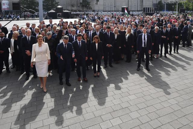 Hungarian politicians, led by Hungary's incoming Prime Minister Peter Magyar (bottom 2ndL) and candidater for speaker of Parliament Agnes Forsthoffer (bottom L) arrive at Kossuth Square for the inaugural session of the new Parliament and the ceremonial swearing in of representatives in Budapest on May 9, 2026. Hungarian parliament's inaugural session on May 9, 2026, will see a record number of women, accounting for more than a quarter of lawmakers, and more than a hundred deputies new to politics. (Photo by Ferenc ISZA / AFP)