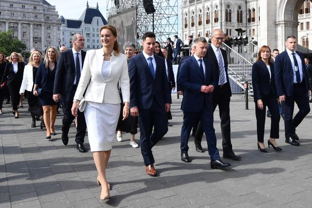 Hungarian politician and candidate for speaker of Parliament Agnes Forsthoffer (5thL) and Hungary's incoming Prime Minister Peter Magyar arrive at Kossuth Square ahead of the inaugural session of the new Parliament and the ceremonial swearing in of representatives in Budapest on May 9, 2026. Hungarian parliament's inaugural session on May 9, 2026, will see a record number of women, accounting for more than a quarter of lawmakers, and more than a hundred deputies new to politics. (Photo by Ferenc ISZA / AFP)