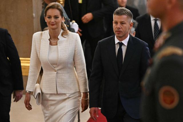 Hungary's incoming Prime Minister Peter Magyar (centre R) and candidater for speaker of Parliament Agnes Forsthoffer (centre L) arrive for the inaugural session of the new Parliament and the ceremonial swearing in of representatives in Budapest on May 9, 2026. Hungarian parliament's inaugural session on May 9, 2026, will see a record number of women, accounting for more than a quarter of lawmakers, and more than a hundred deputies new to politics. (Photo by Attila KISBENEDEK / AFP)