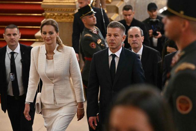Hungary's incoming Prime Minister Peter Magyar (centre R) and candidater for speaker of Parliament Agnes Forsthoffer (centre L) arrive for the inaugural session of the new Parliament and the ceremonial swearing in of representatives in Budapest on May 9, 2026. Hungarian parliament's inaugural session on May 9, 2026, will see a record number of women, accounting for more than a quarter of lawmakers, and more than a hundred deputies new to politics. (Photo by Attila KISBENEDEK / AFP)