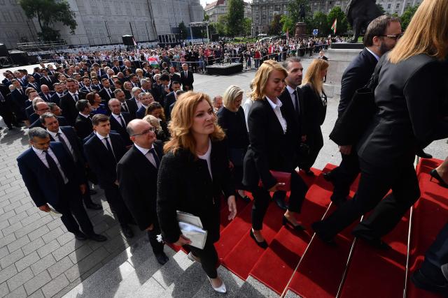 Hungarian politicians arrive at Kossuth Square for the inaugural session of the new Parliament and the ceremonial swearing in of representatives in Budapest on May 9, 2026. Hungarian parliament's inaugural session on May 9, 2026, will see a record number of women, accounting for more than a quarter of lawmakers, and more than a hundred deputies new to politics. (Photo by Ferenc ISZA / AFP)