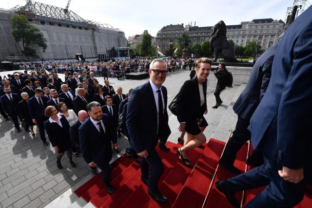 Hungarian politicians arrive at Kossuth Square for the inaugural session of the new Parliament and the ceremonial swearing in of representatives in Budapest on May 9, 2026. Hungarian parliament's inaugural session on May 9, 2026, will see a record number of women, accounting for more than a quarter of lawmakers, and more than a hundred deputies new to politics. (Photo by Ferenc ISZA / AFP)