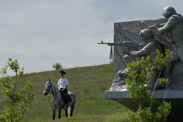 A Russian police officer rides a horse past a monument during a ceremony marking the 81st anniversary of the victory over Nazi Germany in World War II at the Savur-Mohyla memorial in the Donetsk region, Russian-controlled Ukraine on May 8, 2026, amid the ongoing Russian-Ukrainian conflict. (Photo by AFP)
