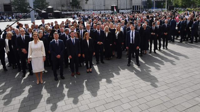 Hungarian politicians, led by Hungary's incoming Prime Minister Peter Magyar (bottom row 2ndL) and candidater for speaker of Parliament Agnes Forsthoffer (bottom row L) arrive at Kossuth Square for the inaugural session of the new Parliament and the ceremonial swearing in of representatives in Budapest on May 9, 2026. Hungarian parliament's inaugural session on May 9, 2026, will see a record number of women, accounting for more than a quarter of lawmakers, and more than a hundred deputies new to politics. (Photo by Ferenc ISZA / AFP)