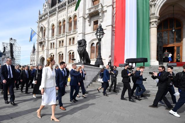 Hungarian politicians, led by Hungary's incoming Prime Minister Peter Magyar (C) and candidate for speaker of Parliament Agnes Forsthoffer (centre L) arrive at Kossuth Square for the inaugural session of the new Parliament and the ceremonial swearing in of representatives in Budapest on May 9, 2026. Hungarian parliament's inaugural session on May 9, 2026, will see a record number of women, accounting for more than a quarter of lawmakers, and more than a hundred deputies new to politics. (Photo by Ferenc ISZA / AFP)