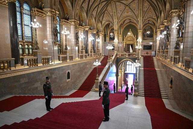 Honour guards stand on the main hall stairs of the Parliament building for the inaugural session of the new Parliament and the ceremonial swearing in of representatives in Budapest on May 9, 2026. Hungarian parliament's inaugural session on May 9, 2026, will see a record number of women, accounting for more than a quarter of lawmakers, and more than a hundred deputies new to politics. (Photo by Attila KISBENEDEK / AFP)