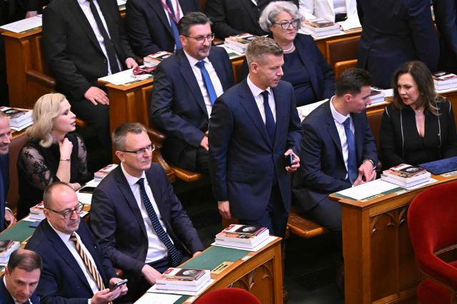 Hungary's incoming Prime Minister Peter Magyar (C) arrives ahead of his official swear-in ceremony at the Hungarian parliament in Budapest on May 9, 2026. Pro-European conservative Peter Magyar will be officially sworn in as Prime Minister by the Hungarian parliament on May 9, 2026, just under a month after his landslide victory in the parliamentary elections against nationalist Viktor Orban. Hungarian parliament's inaugural session on May 9, 2026, will see a record number of women, accounting for more than a quarter of lawmakers, and more than a hundred deputies new to politics. (Photo by Attila KISBENEDEK / AFP)