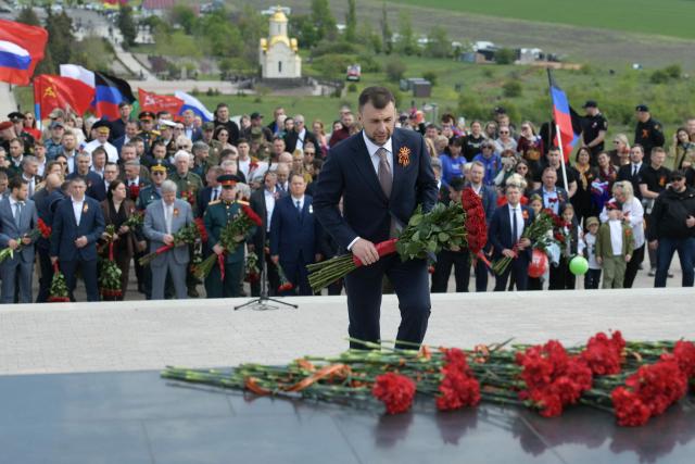 Denis Pushilin, the Moscow-installed head of the Donetsk region of Russian-controlled Ukraine, lays flowers during a ceremony marking the 81st anniversary of the victory over Nazi Germany in World War II at the Savur-Mohyla memorial in the Donetsk region, Russian-controlled Ukraine on May 8, 2026, amid the ongoing Russian-Ukrainian conflict. (Photo by AFP)