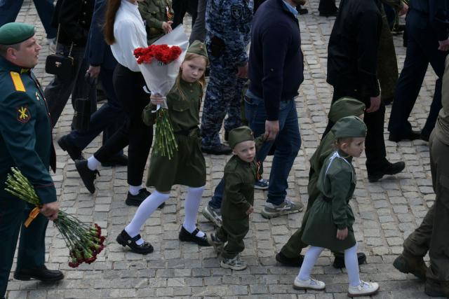 Children wearing Soviet-era uniforms attend a ceremony marking the 81st anniversary of the victory over Nazi Germany in World War II at the Savur-Mohyla memorial in the Donetsk region, Russian-controlled Ukraine on May 8, 2026, amid the ongoing Russian-Ukrainian conflict. (Photo by AFP)