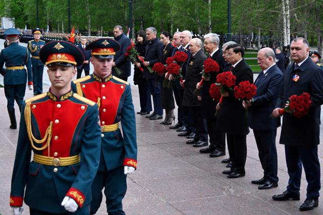 Russian President Vladimir Putin and foreign leaders attend a ceremony to lay flowers at the Tomb of the Unknown Soldier by the Kremlin wall in central Moscow on May 9, 2026. Russia celebrates the 81st anniversary of the Soviet Union's victory over Nazi Germany in World War Two (WWII). (Photo by Alexander NEMENOV / POOL / AFP)