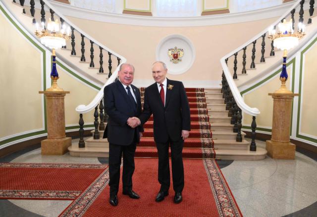 In this pool photograph distributed by the Russian state agency Sputnik, Russia's President Vladimir Putin welcomes Malaysia's King Sultan Ibrahim prior to the Victory Day military parade, at the Kremlin in Moscow on May 9, 2026. Russia celebrates the 81st anniversary of the Soviet Union's victory over Nazi Germany in World War Two (WWII). (Photo by Grigory SYSOYEV / POOL / AFP)
