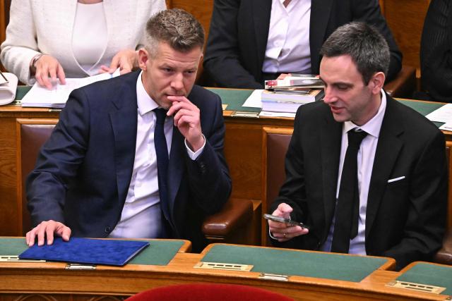 Hungary's incoming Prime Minister Peter Magyar (L) reacts next to his brother-in-law and Hungarian politician Marton Mellethei-Barna during the inaugural session of the new Parliament and the ceremonial swearing in of representatives in Budapest on May 9, 2026. Hungarian parliament's inaugural session on May 9, 2026, will see a record number of women, accounting for more than a quarter of lawmakers, and more than a hundred deputies new to politics. (Photo by Attila KISBENEDEK / AFP)