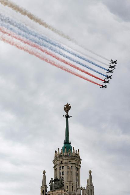Russian Sukhoi SU-25 fighter jets release smoke in the colours of the Russian tricolor flag as they fly over central Moscow during the Victory Day military parade on May 9, 2026. Russia celebrates the 81st anniversary of the Soviet Union's victory over Nazi Germany in World War Two (WWII). (Photo by TATYANA MAKEYEVA / AFP)