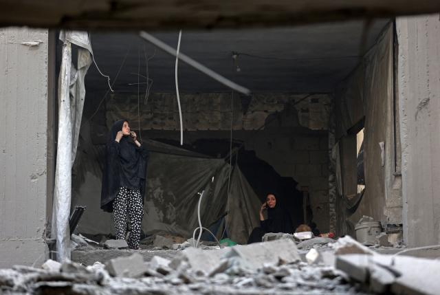 Palestinians watch from inside a damaged building, a day after of an Israeli strike at the Shati refugee camp (Beach) in Gaza City, on May 9, 2026. Despite an October ceasefire, Gaza remains gripped by daily violence as Israeli strikes continue, with both the military and Hamas accusing one another of violating the truce. (Photo by Omar AL-QATTAA / AFP)