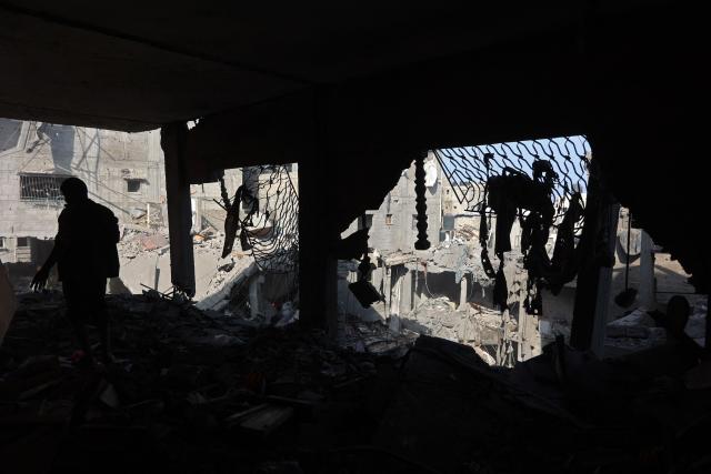 A Palestinian man inspects the site, a day after of an Israeli strike at the Shati refugee camp (Beach) in Gaza City, on May 9, 2026. Despite an October ceasefire, Gaza remains gripped by daily violence as Israeli strikes continue, with both the military and Hamas accusing one another of violating the truce. (Photo by Omar AL-QATTAA / AFP)