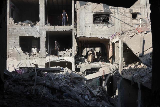 Palestinians inspect the site, a day after of an Israeli strike at the Shati refugee camp (Beach) in Gaza City, on May 9, 2026. Despite an October ceasefire, Gaza remains gripped by daily violence as Israeli strikes continue, with both the military and Hamas accusing one another of violating the truce. (Photo by Omar AL-QATTAA / AFP)
