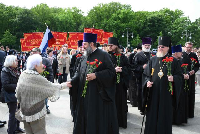 Clergymen arrive to pay their respect at the Soviet War Memorial Tiergarten in Berlin on May 9, 2026, the 81st anniversary of the 1945 victory against Nazi Germany. (Photo by RALF HIRSCHBERGER / AFP)