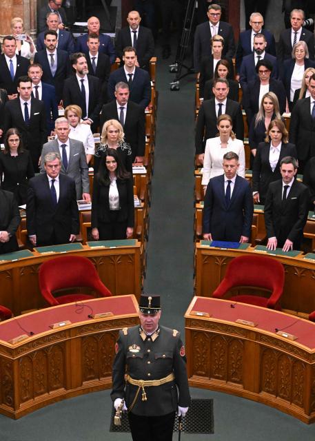 Hungarian politicians including Hungary's incoming Prime Minister Peter Magyar (bottom row 2ndR), his brother-in-law and Hungarian politician Marton Mellethei-Barna and Hungarian politician and candidate for speaker of Parliament Agnes Forsthoffer(2nd row 2ndR) stand during the inaugural session of the new Parliament and the ceremonial swearing in of representatives in Budapest on May 9, 2026. Hungarian parliament's inaugural session on May 9, 2026, will see a record number of women, accounting for more than a quarter of lawmakers, and more than a hundred deputies new to politics. (Photo by Attila KISBENEDEK / AFP)